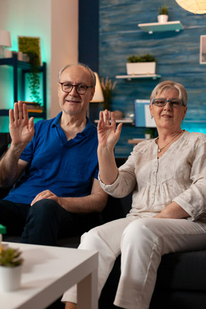 pov-of-retired-couple-waving-hands-on-video-call-c-2023-11-27-05-13-36-utc-scaled